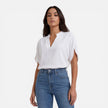 Lightweight women's chiffon V-neck blouse by FJØRNA, perfect for summer casual wear, shown in a light, flowy fabric.