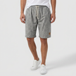 Men's linen shorts by FJØRNA with elasticated waist and drawstring, perfect for summer beach outings.