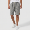 Men's linen shorts by FJØRNA with elasticated waist and drawstring, perfect for summer beach outings.