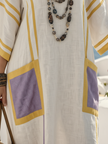 FJØRNA women's summer maxi dress with V-neck, short sleeves, and pockets, featuring a flowing design perfect for warm weather.