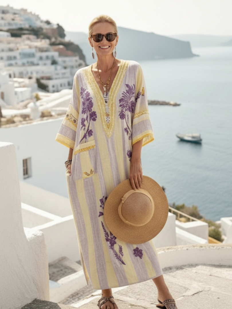 FJØRNA women's floral summer maxi dress with V-neck and short sleeves, featuring a vibrant, flowy design perfect for warm weather.