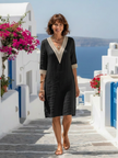 Women’s V-neck flowy summer dress by FJØRNA, lightweight fabric, and relaxed fit, shown on a model with a natural outdoor setting.