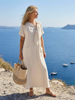 FJØRNA women's summer maxi dress with short sleeves and wrap design, shown in a flowy, lightweight fabric.