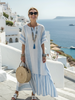 FJØRNA women's summer maxi dress with striped pattern, short sleeves, and wrap design, perfect for warm-weather styling.