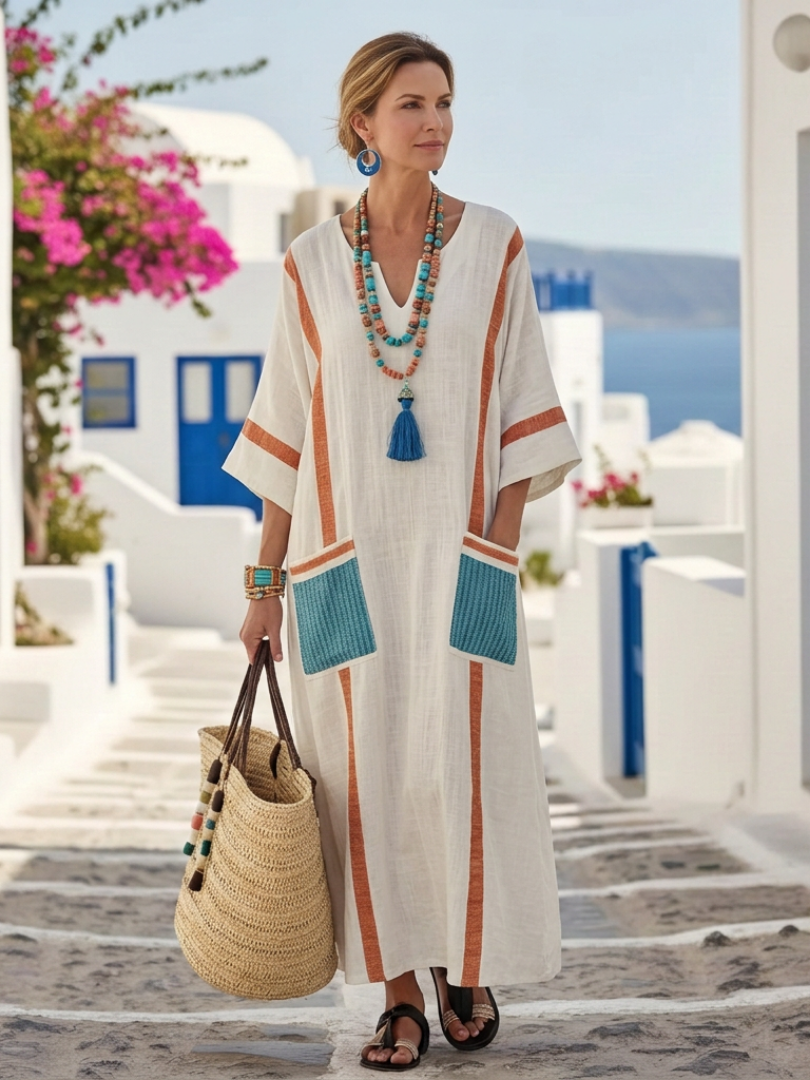 Flowy summer maxi dress for women by FJØRNA featuring pockets, lightweight fabric, and a relaxed fit for warm-weather wear.