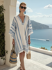 FJØRNA women's striped wrap summer dress, lightweight and stylish, shown hanging on a wooden hanger.