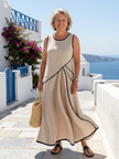 FJØRNA summer maxi dress for women, sleeveless and flowy, lightweight fabric ideal for warm weather, shown in a bright outdoor setting.
