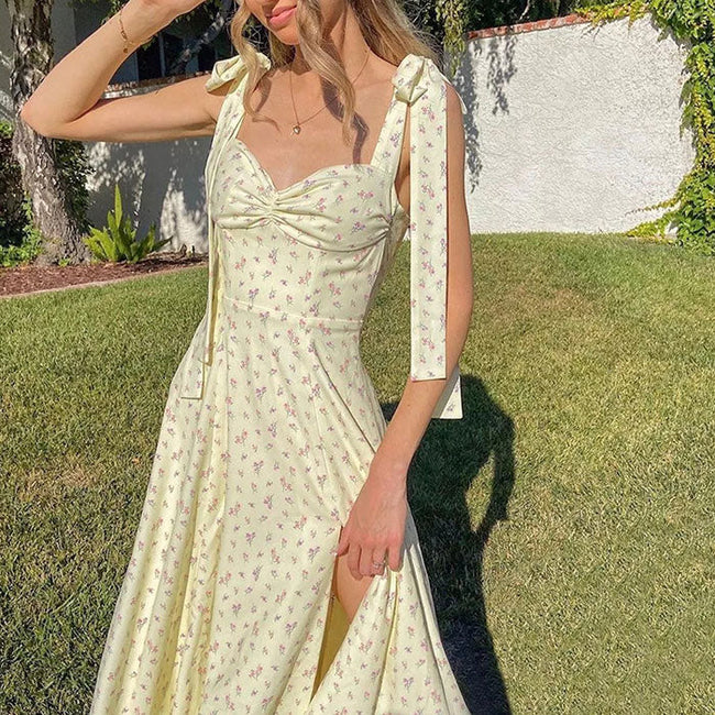 White FJØRNA cottagecore midi dress with tie straps, featuring a flowy, vintage-inspired design perfect for casual or streetwear looks.