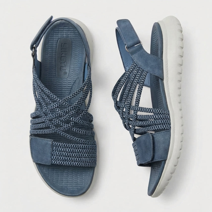 FJØRNA orthopedic criss-cross strappy women's sandals with adjustable straps, shown from top and side angles.