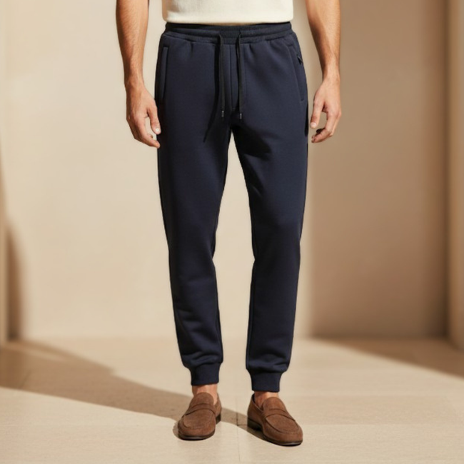 Men's FJØRNA drawstring joggers in black and grey, relaxed fit casual pants made from lightweight fabric for comfort and style.