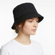 Unisex minimalist bucket hat by FJØRNA with stitched brim, lightweight fabric, and simple design for casual wear.