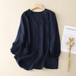 FJØRNA women's summer linen blouse with V-neck, lightweight and casual, shown in a natural fabric and relaxed fit.