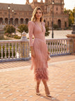 Elegant women's dress by FJØRNA with a V-neck and fringe detail, featuring a flowing silhouette and stylish design.