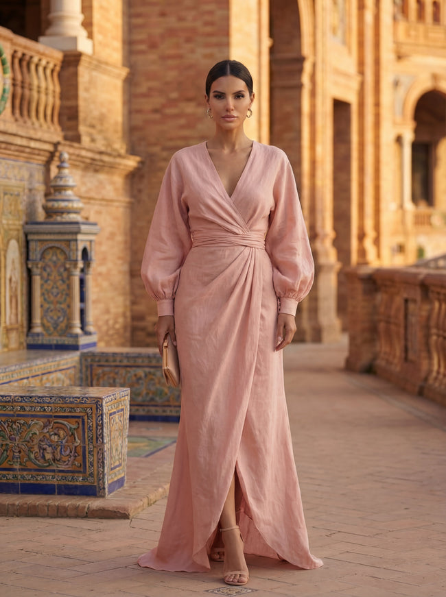 Woman wearing an elegant V-neck linen maxi dress by FJØRNA, flowing and stylish for summer or casual occasions.