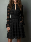 Black FJØRNA lace mini dress with sheer layered panels, featuring a stylish and elegant design perfect for evening wear.