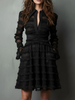 Black FJØRNA mini dress with sheer layered panels and lace detailing, front view showcasing fitted silhouette and transparent fabric accents.