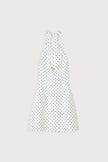 White polka dot mini dress by FJØRNA featuring a voluminous skirt, perfect for party and daytime wear.