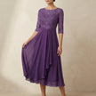 Violet embroidered A-line midi dress from FJØRNA with sheer sleeves and convenient pockets, stylish and elegant for special occasions.