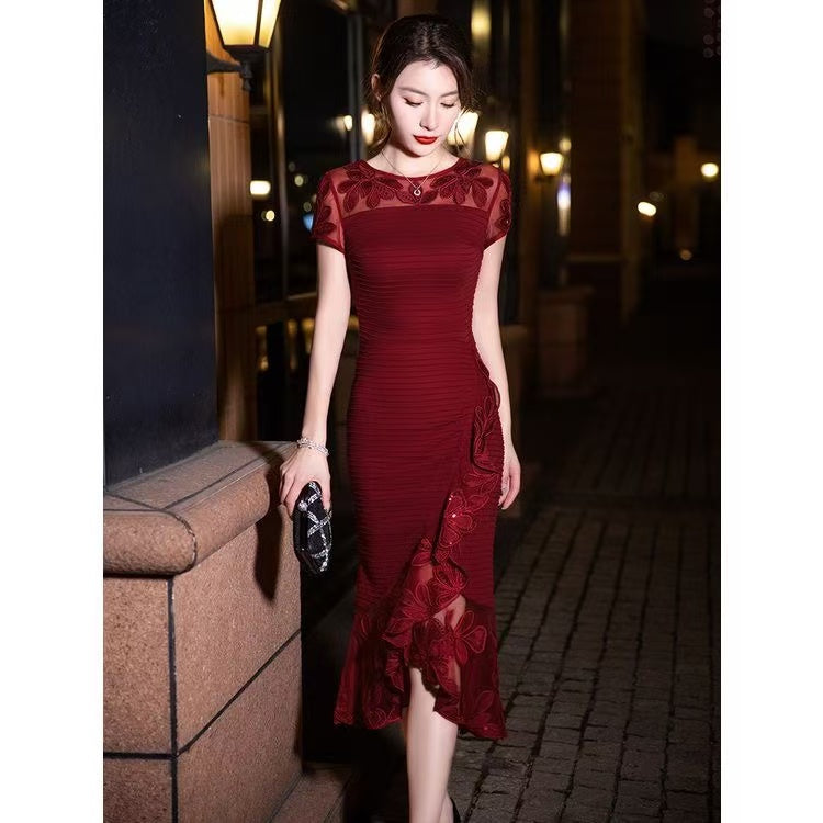 Black embroidered tulle patchwork fishtail dress by FJØRNA, featuring intricate embroidery and elegant tie details.