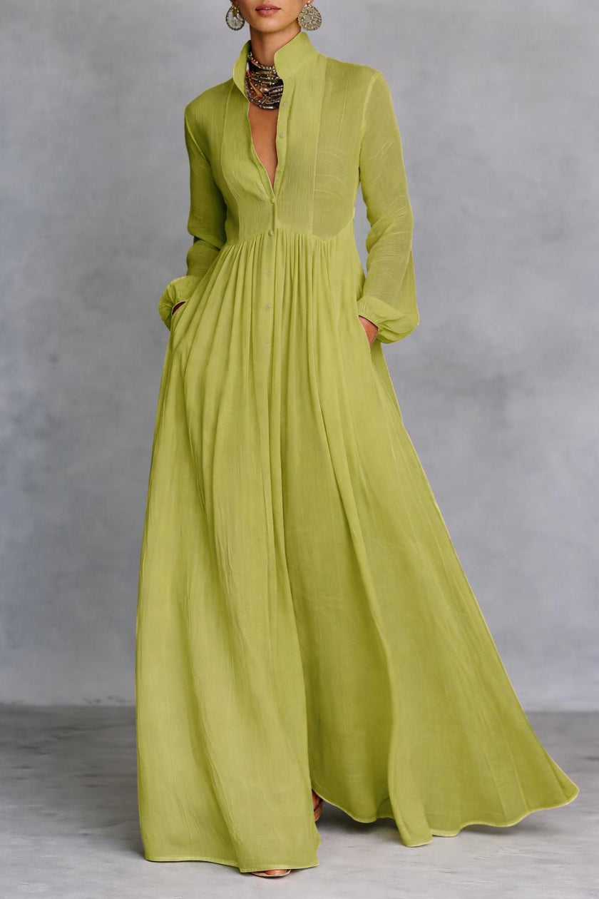 White FJØRNA maxi dress with stand collar, button front, long sleeves, and flowing silhouette, perfect for elegant occasions.