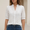 White women's relaxed fit V-neck blouse with embroidered floral detailing by FJØRNA, showcasing elegant, breathable fabric.