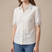 White women's summer blouse by FJØRNA featuring a V-neck and puff sleeves, made of lightweight linen fabric.