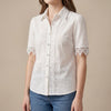 White women's summer blouse by FJØRNA featuring a V-neck and puff sleeves, made of lightweight linen fabric.