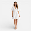 Women's white lace summer dress by FJØRNA featuring a V-neck and A-line silhouette, perfect for wedding guest attire.