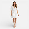 Women's white lace summer dress by FJØRNA featuring a V-neck and A-line silhouette, perfect for wedding guest attire.