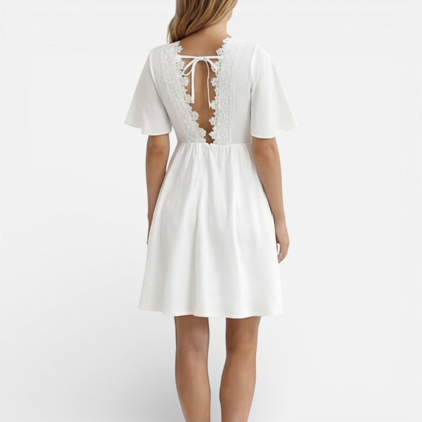 Women's white lace summer dress by FJØRNA featuring a V-neck, A-line silhouette, perfect for wedding guest occasions.