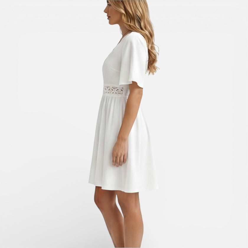 Women's white lace summer dress by FJØRNA featuring a V-neck and A-line silhouette, perfect for wedding guest attire.