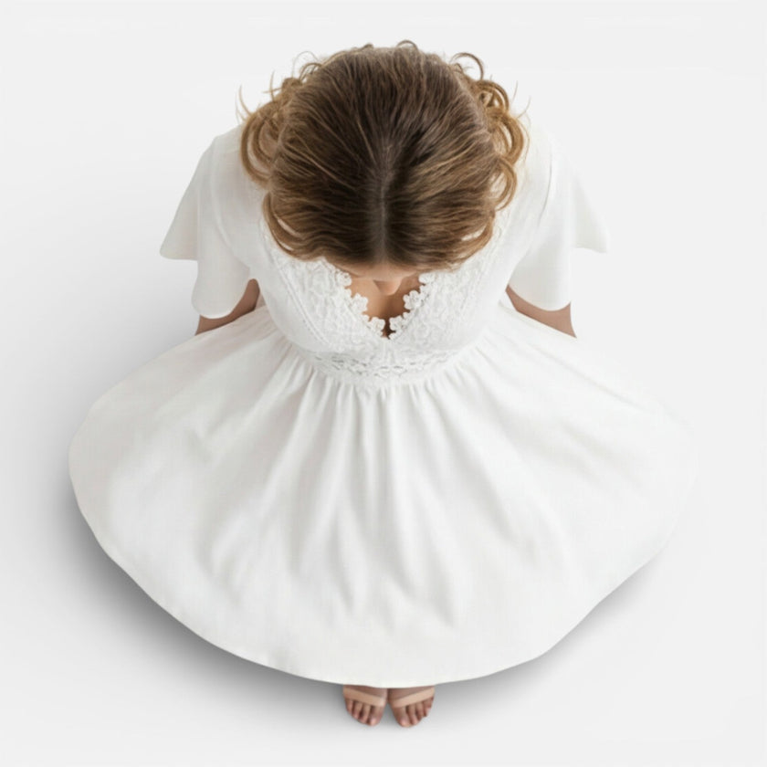Women's white lace summer dress by FJØRNA featuring a V-neck and A-line silhouette, perfect for wedding guest attire.