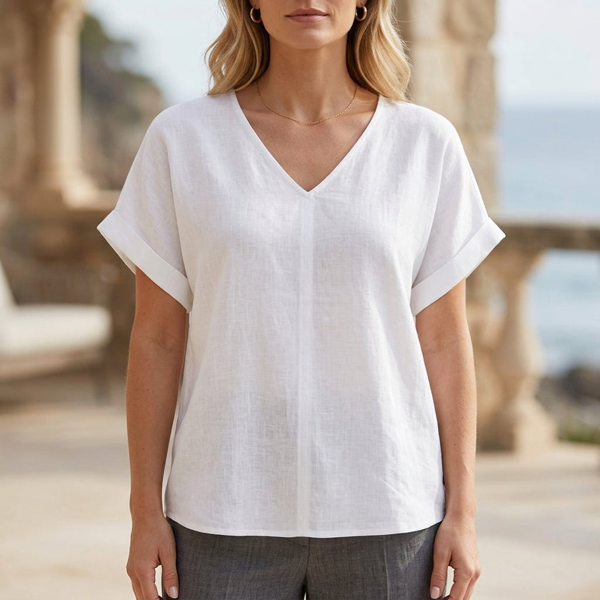 White women's summer blouse by FJØRNA with V-neck and short sleeves, made from denim fabric.