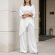 FJØRNA white relaxed two-piece set with flowing wide-leg pants and a matching top, perfect for casual or elegant wear.