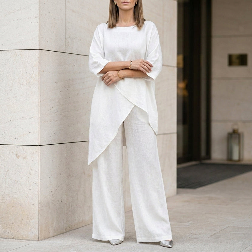 FJØRNA white relaxed two-piece set with flowing wide-leg pants and a matching top, perfect for casual or elegant wear.