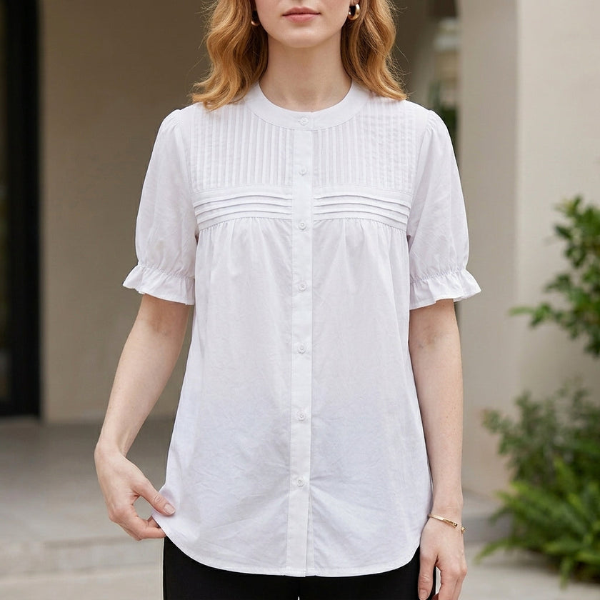 White women's summer blouse by FJØRNA with puff sleeves and denim button-front design, styled with a casual, breezy look.
