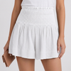 White women's summer shorts by FJØRNA featuring cotton fabric and ruffle details, perfect for warm-weather casual wear.