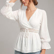White FJØRNA women’s summer blouse with V-neck and ruffle details, made of lightweight linen, perfect for casual warm weather wear.