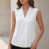 White sleeveless V-neck blouse for women with front pleats, tailored design by FJØRNA, casual and chic top for warm weather.