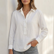 White V-neck popover shirt for women with cuffed sleeves and relaxed fit by FJØRNA, shown on a model.