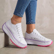 White FJØRNA women's orthopedic lace-up sneakers with supportive design, ideal for comfortable everyday walking.