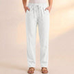 White linen summer trousers for women with pockets by FJØRNA, featuring a relaxed fit and lightweight fabric.