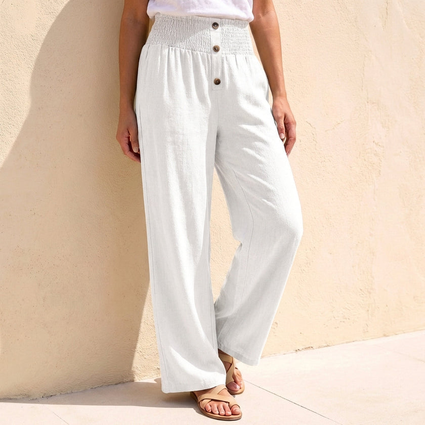 White linen summer trousers for women with button front by FJØRNA, casual and breathable for warm weather.