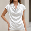 White FJØRNA summer blouse for women with a cowl neck and short satin sleeves, stylish and lightweight top for warm weather.