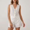 White floral two-piece summer set for women by FJØRNA, featuring a V-neck top and matching skirt or shorts.