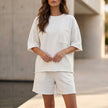 FJØRNA oversized white two-piece set with relaxed fit, chest pocket, and wide-leg shorts, casual and comfortable loungewear