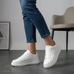 White FJØRNA women's orthopedic sneakers with lace-up design and arch support, featuring a comfortable and supportive shoe profile.