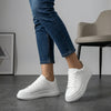 White FJØRNA women's orthopedic sneakers with lace-up design and arch support, featuring a comfortable and supportive shoe profile.