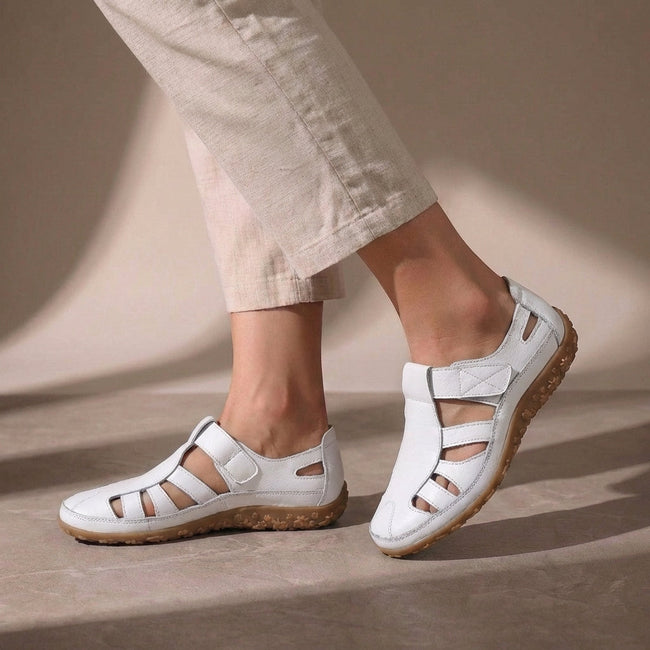 White FJØRNA orthopedic closed-toe sandals with cutout details and a comfortable fit, showcasing the stylish design.