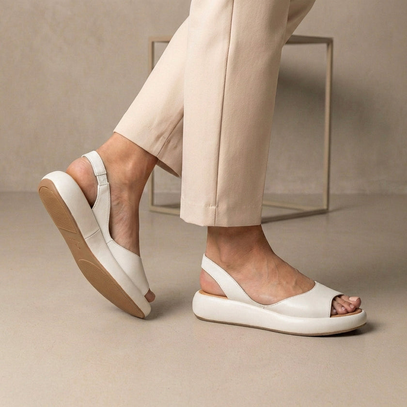 White FJØRNA women's orthopedic wedge sandals with adjustable straps, featuring supportive soles and comfortable design for everyday wear.